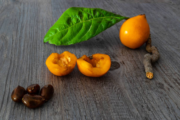 Fresh and dried žižole fruits displayed in wooden bowl with leaves showing natural color texture and healthy organic appearance
