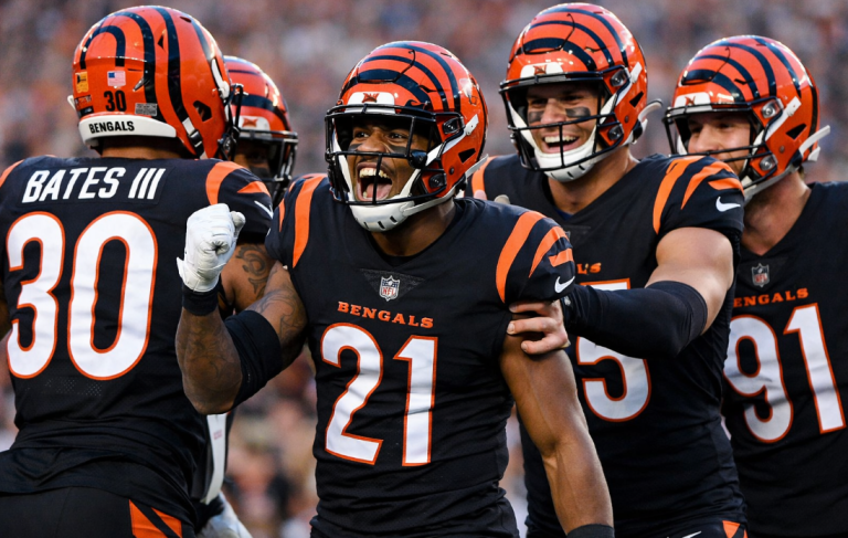 mike hilton bengals reunion defensive celebration on field with teammates showing leadership and unity